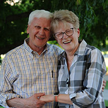 A couple smiling. Links to Gifts That Pay You Income